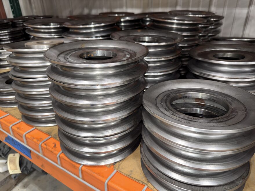 Roll formed sheaves organized on a storage shelf in warehouse